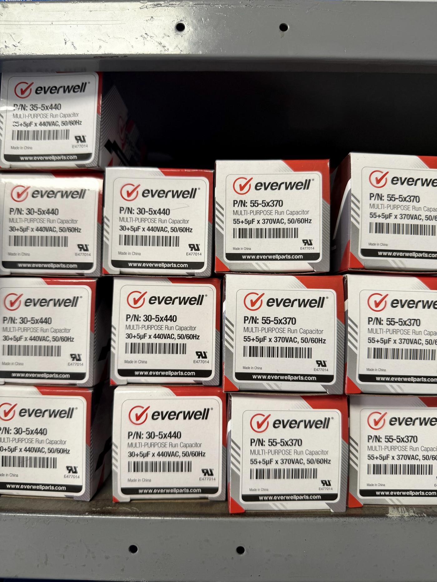Boxed run capacitors on the shelf at Banos HVAC Supply