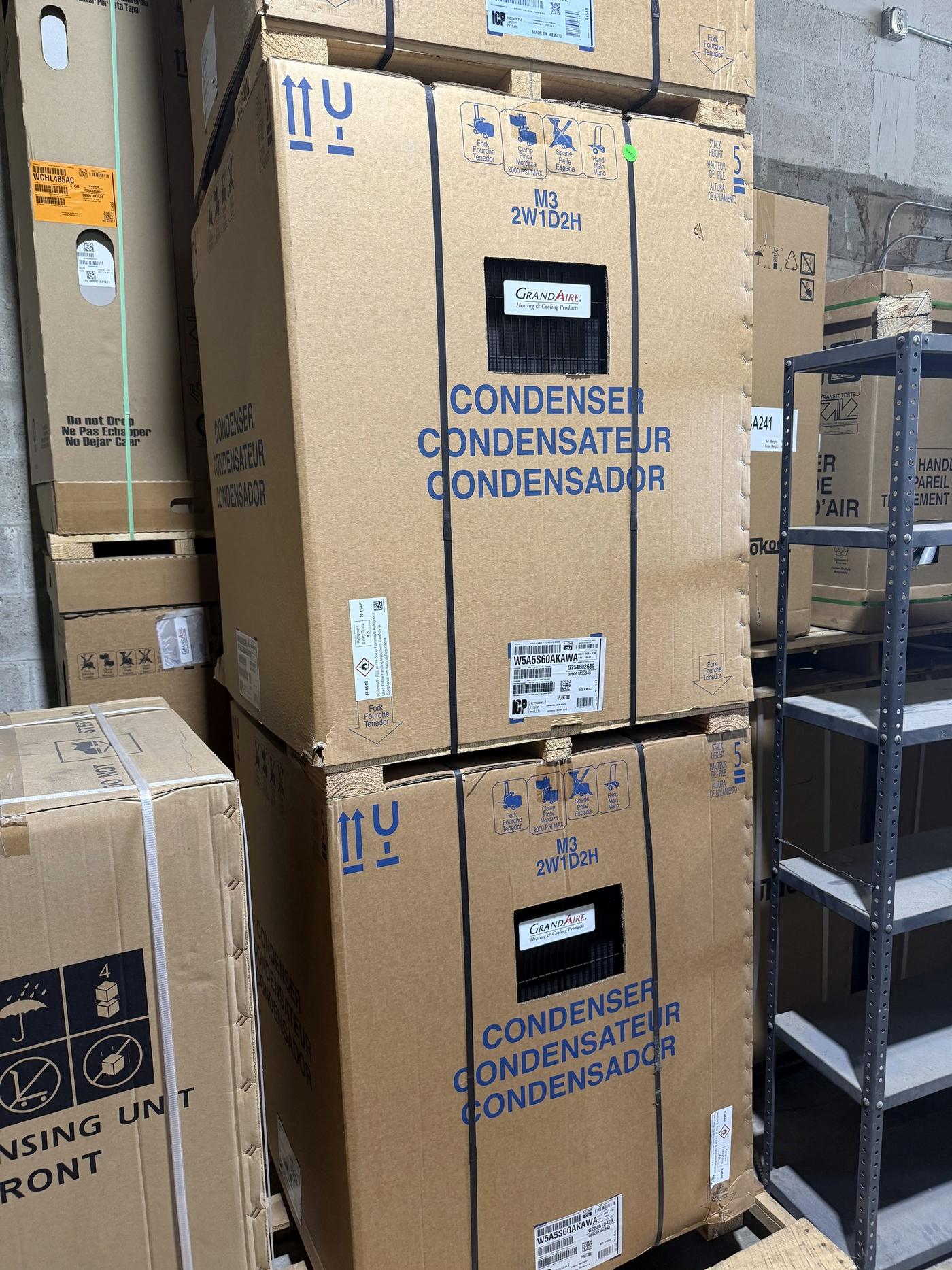 Boxed condensing units stacked in the Banos HVAC warehouse