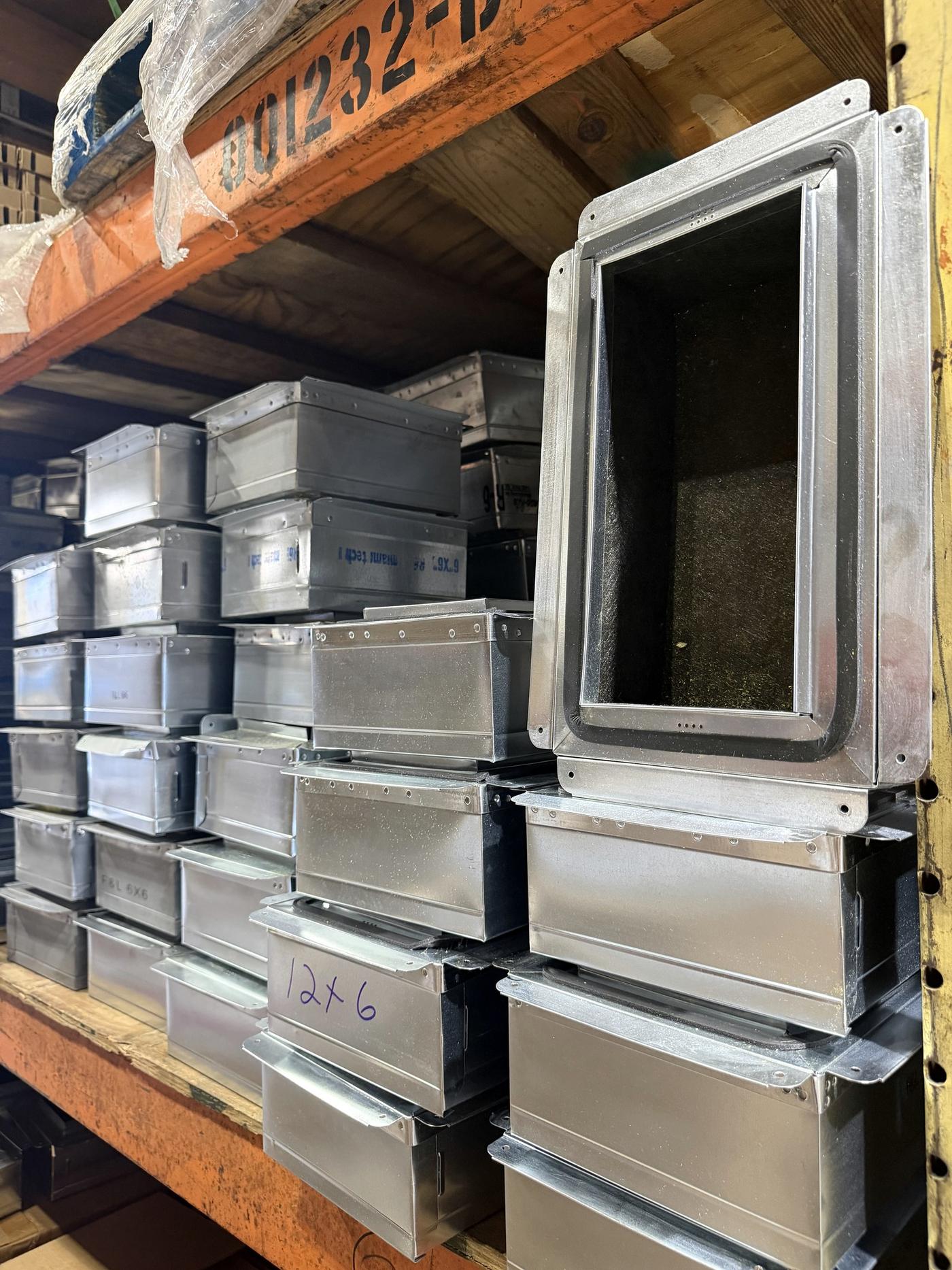 Fabricated sheet-metal duct boot boxes on the racks at Banos HVAC Supply
