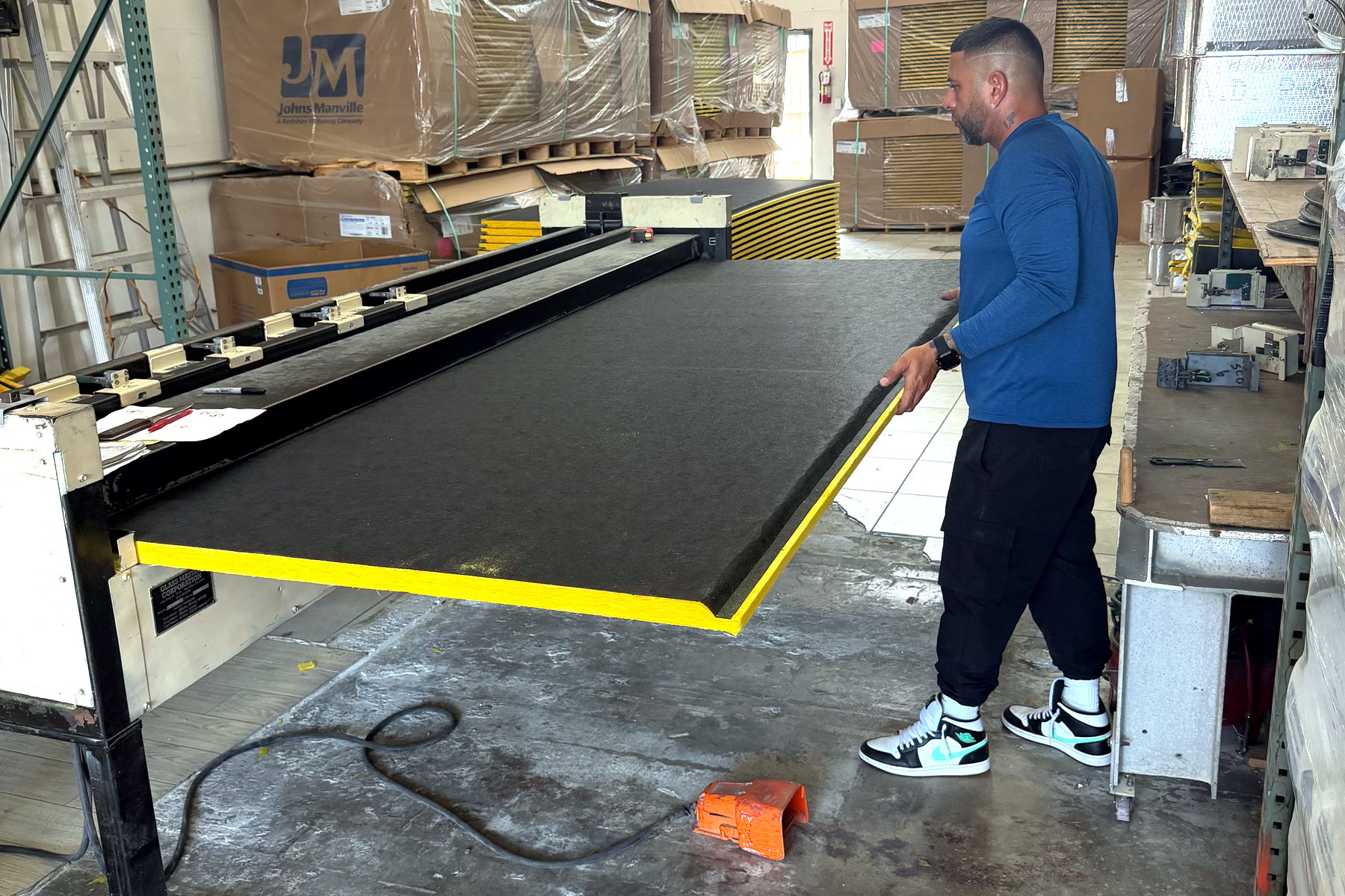 Wide view of the duct board fabrication area inside the Banos HVAC shop