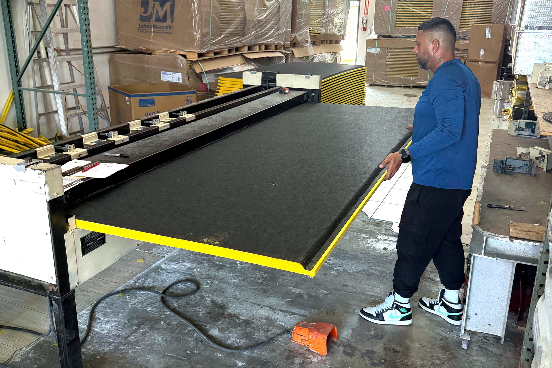 Duct board being squared up on the fabrication table at Banos HVAC