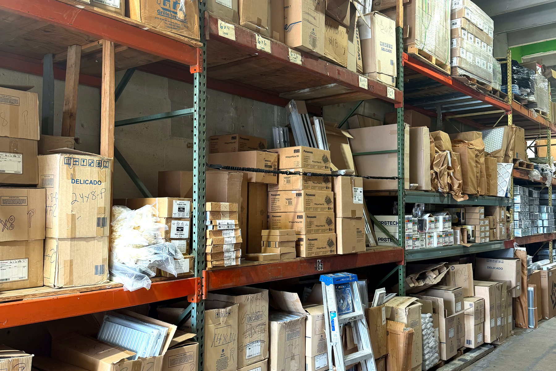 Pallet racking stocked with HVAC parts and equipment at Banos HVAC Supply