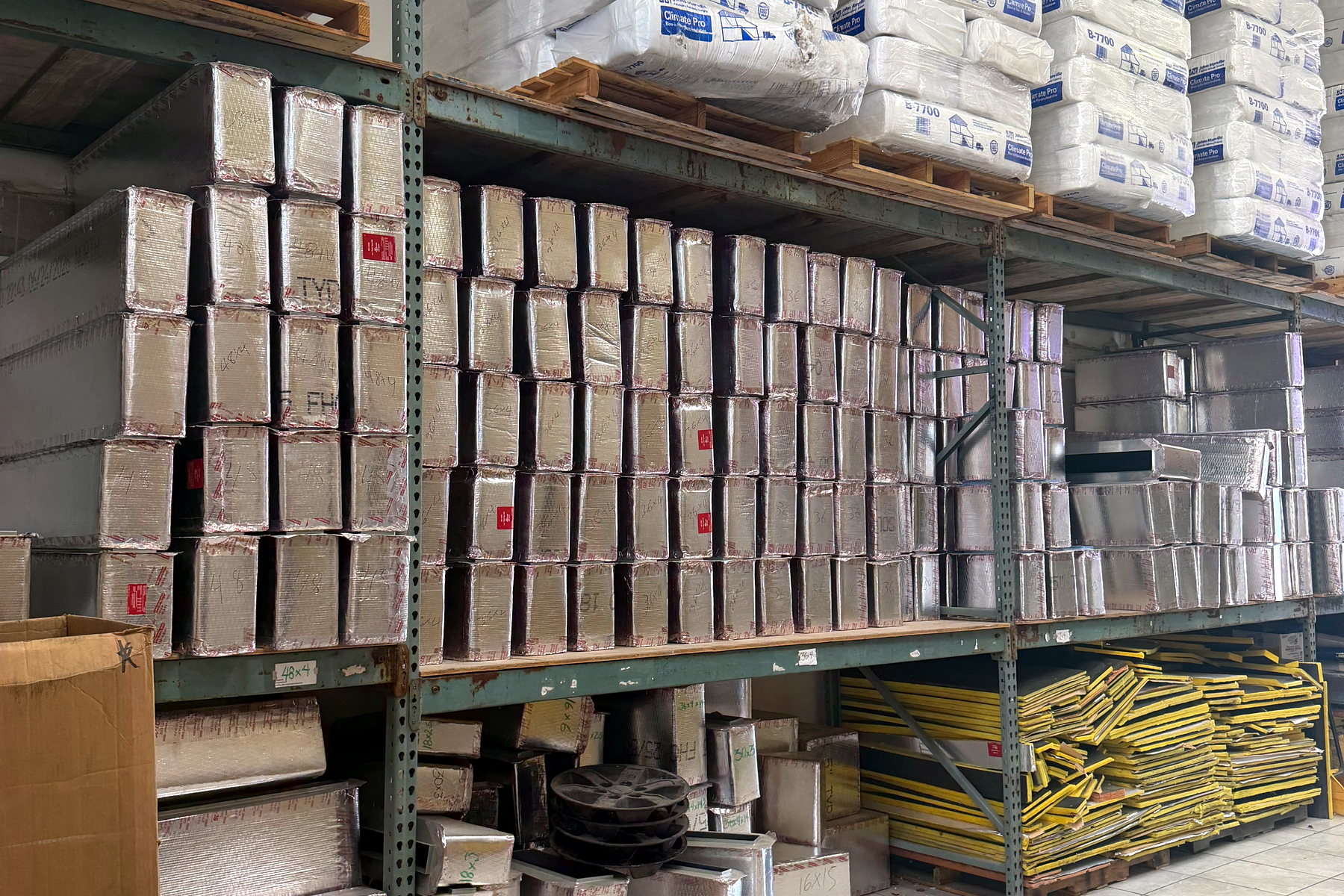 Shelving stocked with boxed grilles and registers ready for same-day pickup